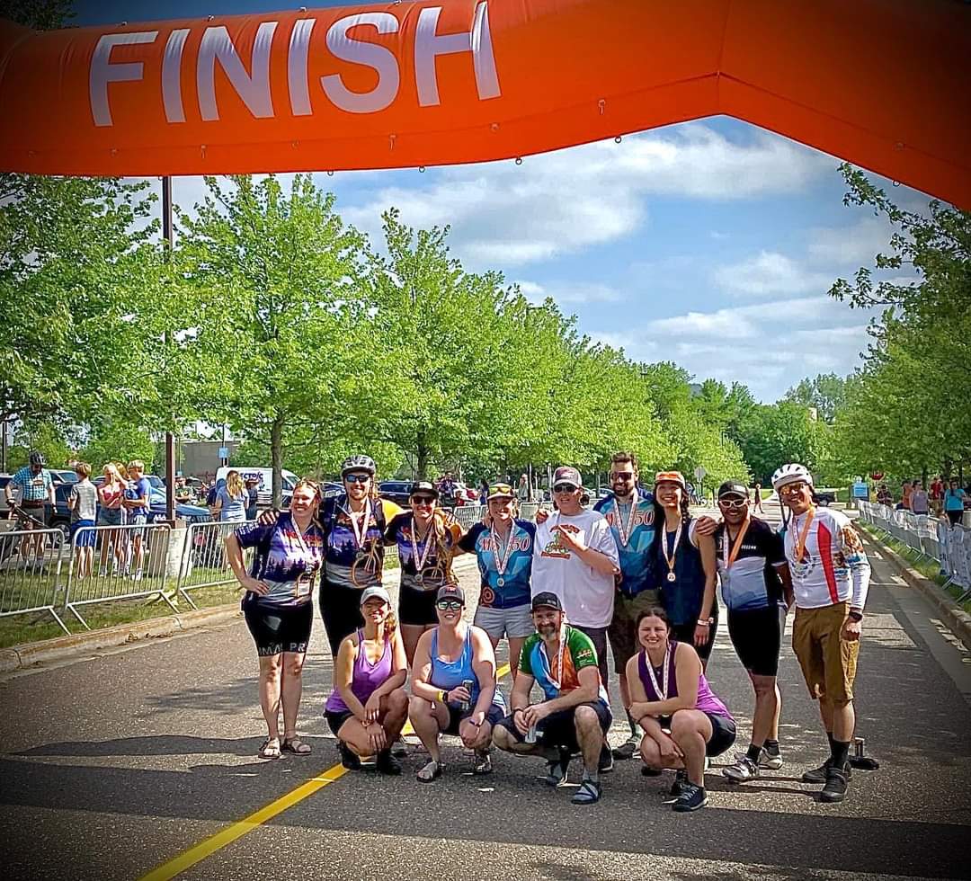 Team at finish line with medals